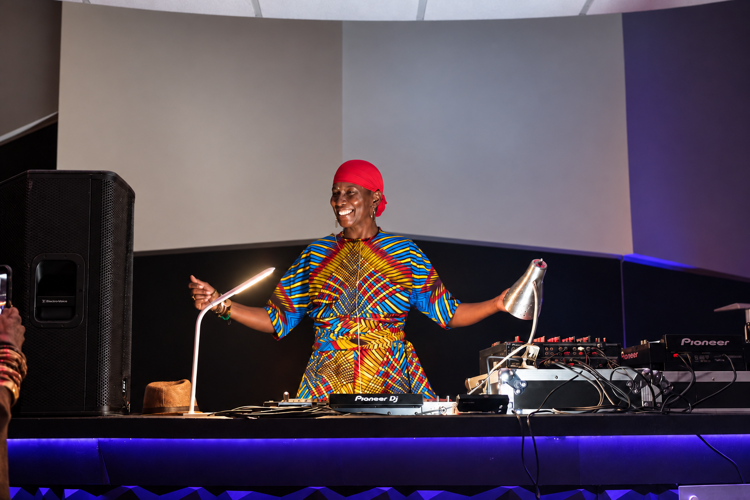 DJ PhreeSpirit smiling behind the decks during a live performance